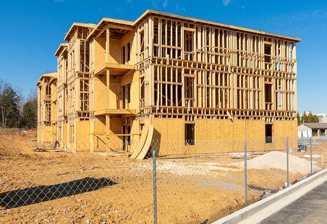 a temporary chain link fence in front of a building under construction, ensuring public safety in Atwater, CA